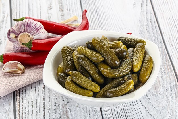 Marinated small cucumbers in the bowl