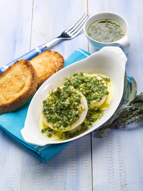 Marinated tomino cheese with herbs