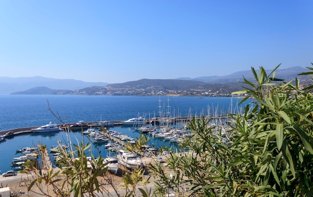 Marine pier with yachts and speedboats Mountains on the other side of the bay Travel photography