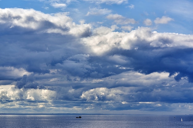 Marine skyline with dark storm clouds and smooth water