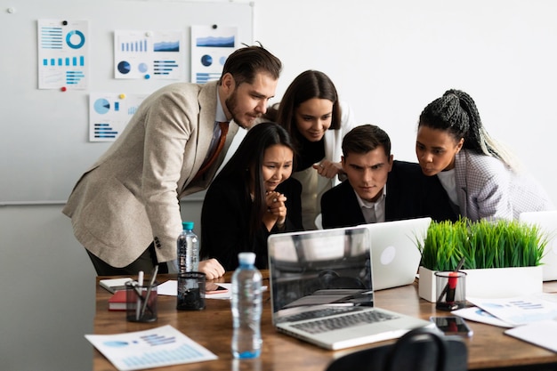 Marketing team group of young modern people in smart casual wear discussing something while working