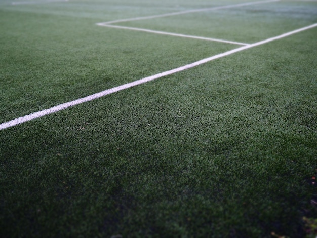 The marking of the football field on the green grass white lines no more than cm or inches wide