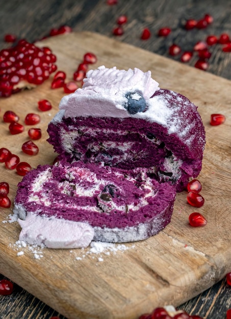 A marooncolored cake with the taste of different berries and a creamy milk filling of cottage cheese with pomegranate seeds