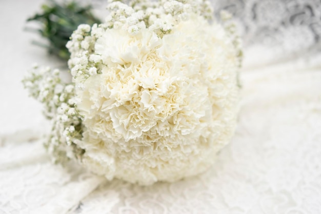 Marriage, Round white bridal bouquet on table with lace fabric and wedding decorations