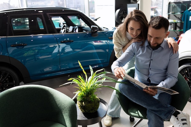 A married couple in a car dealership chooses a complete set of a new car