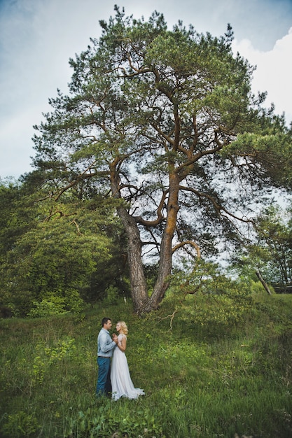 Married couple near a tree in nature