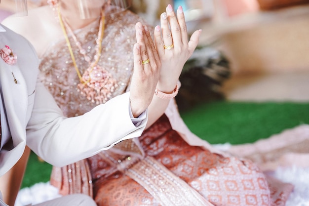 A married couple shows a wedding ring on their finger Wedding in thailand