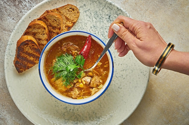 Marrocan harira soup with lamb on a white plate Closeup selective focus