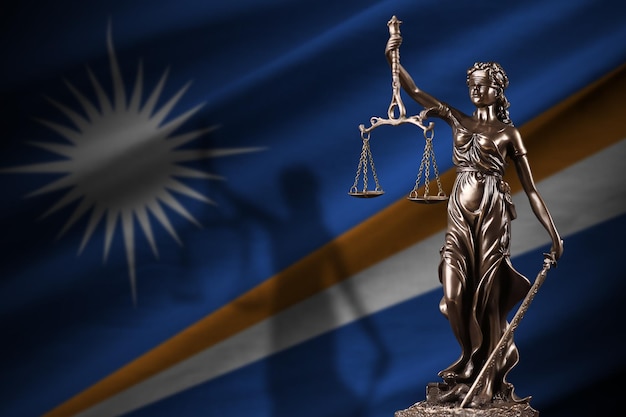 Marshall Islands flag with statue of lady justice and judicial scales in dark room Concept of judgement and punishment