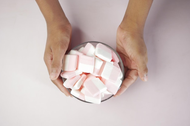 Marshmallow candy in a bowl on blue