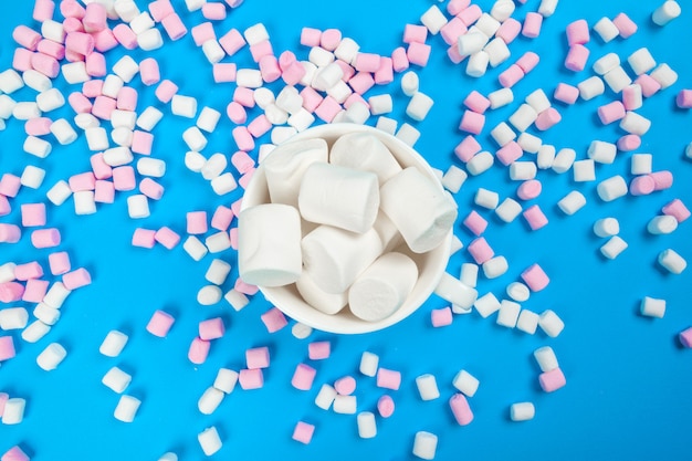 marshmallow laid out on blue paper 