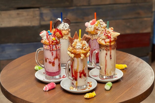 Marshmallow milk shake cocktails with whipped cream, cookies, waffles, treats