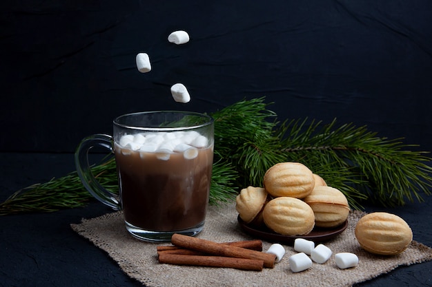 Marshmallows falls in glass mug with hot chocolate cocoa drink. Winter food and drink concept. Flying marshmallow.