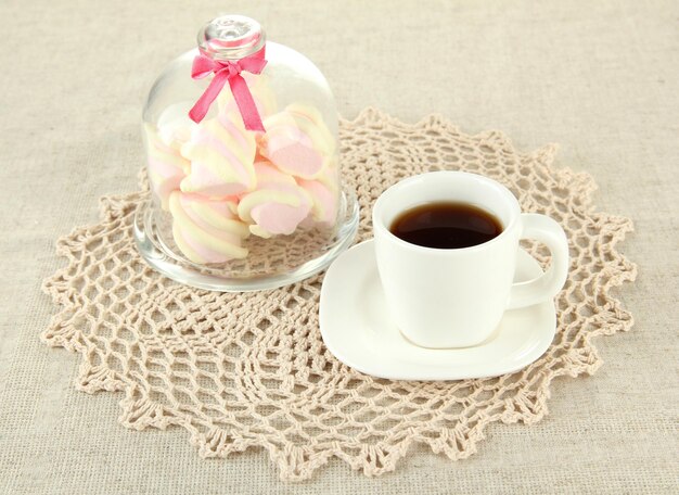 Marshmallows on saucer with transparent cover on light background