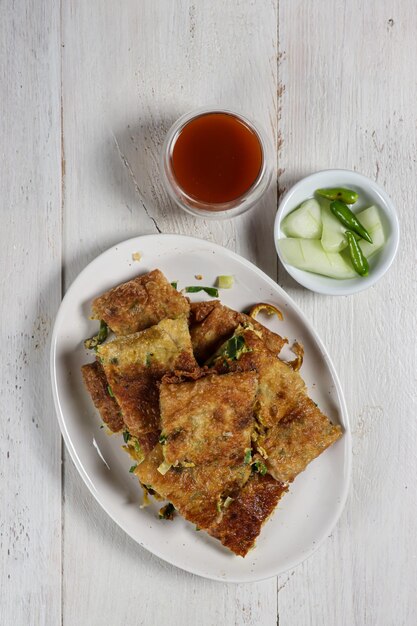 Martabak telur Indonesian street food fried wrap filled with eggsminced meat and vegetables