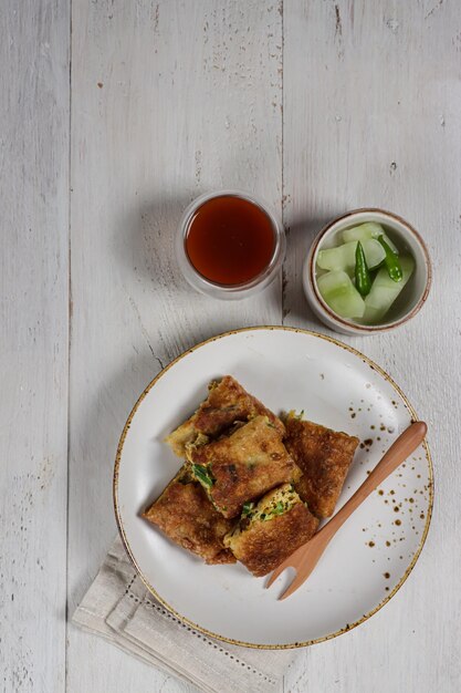 Martabak telur Indonesian street food fried wrap filled with eggsminced meat and vegetables