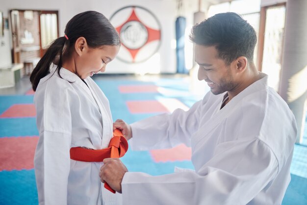 Photo martial arts karate and achievement in studio for fitness help and respect with orange belt sensei student and celebration as people for self defense class gratitude and discipline with support