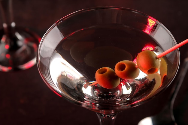 Martini Alcoholic drink martini with olives in a glass on a dark background in the bar on the bar counter bar inventory cocktails