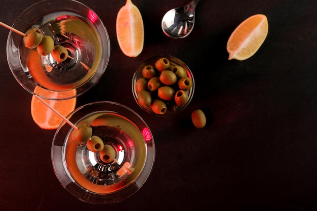 Martini Alcoholic drink martini with olives in a glass on a dark background in the bar on the bar counter bar inventory cocktails