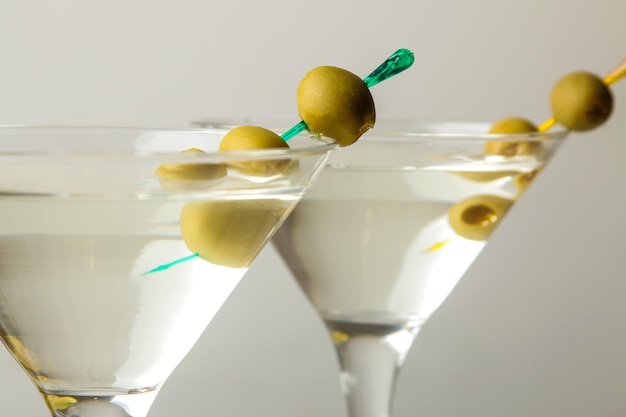 Martini Alcoholic drink martini with olives in a glass on a light background in the bar on the bar counter bar inventory cocktails