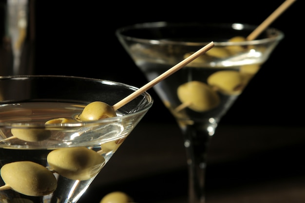 Martini in a glass with green olives