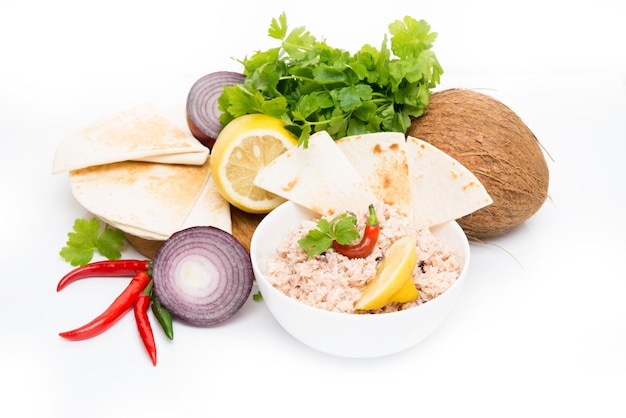 Mas huni, traditional Maldivian breakfast with ingredients on a white background