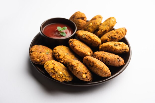 Masala Chana Dal Vada or Parippu or Paruppu Vadai is a Tea Time fried snacks recipe from Maharashtrian and Kerala. served in a plate