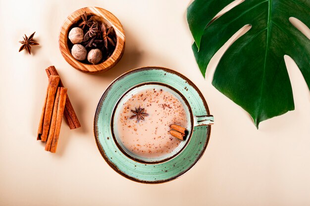 Masala tea indian traditional tea with milk and spices in a cup top view