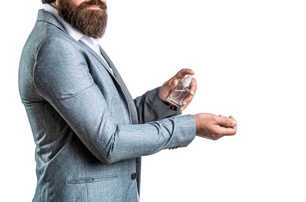 Masculine perfume bearded man in a suit Male holding up bottle of perfume Perfume or cologne bottle and perfumery cosmetics scent cologne bottle male holding cologne