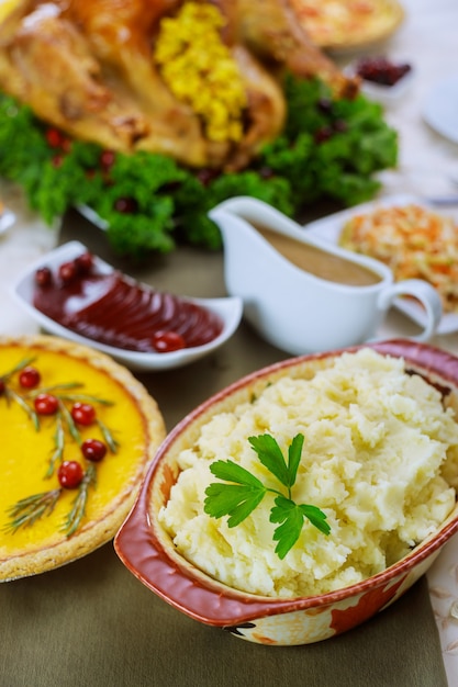 Mashed potatoes, gravy and turkey for Christmas or Thanksgiving dinner table.