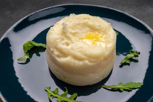 Mashed potatoes on a plate on a dark background