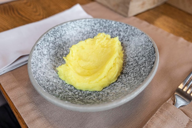 Mashed potatoes in a plate on table in a restaurant