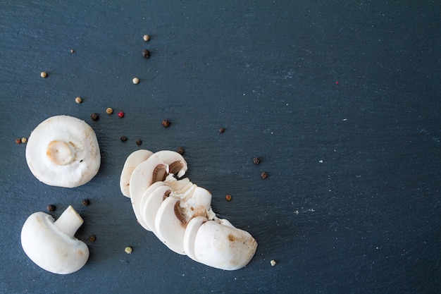 Mashrooms on dark stone background