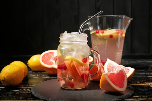 Mason jar of cold tea on dark wooden table