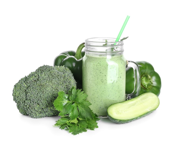 Mason jar of healthy smoothie with vegetables on white surface