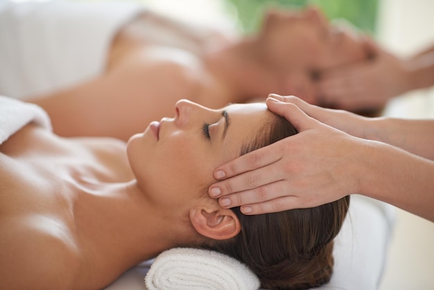 Massage head and couple in spa to relax with luxury treatment for wellness on holiday or vacation Beauty care and calm people together in hotel salon or resort for healthy facial or skincare