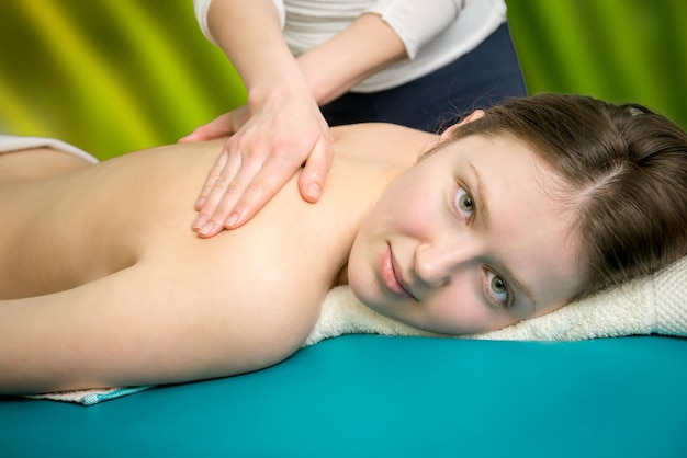 Massage on the shoulder of a young girl