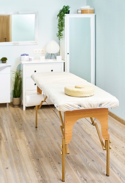 Massage table, beautician cabinet, beauty salon interior details