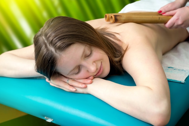 Massage with bamboo sticks for a young girl