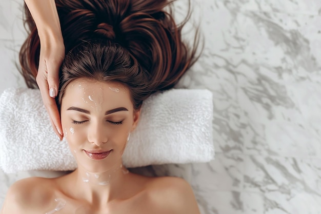 Photo massage woman with a white towel on her head is covering her eyes