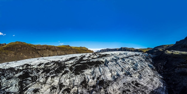 Massive glacier panorama under clear blue sky