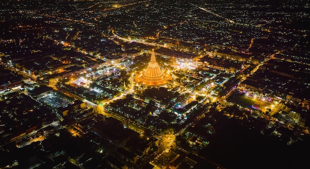 A massive golden pagoda Located in the sunset community of Phra Pathom Chedi Nakhon Pathom Thailand The measurement was made public Thailand aerial view of a road roundabout with auto lots Lovely