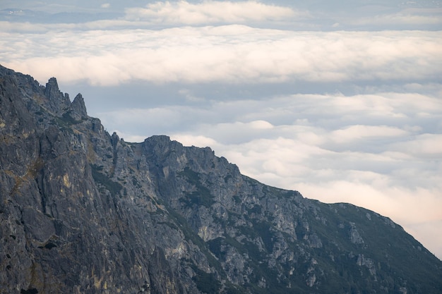 Massive mountain ridge towering above the clouds during sunset slovakia europe