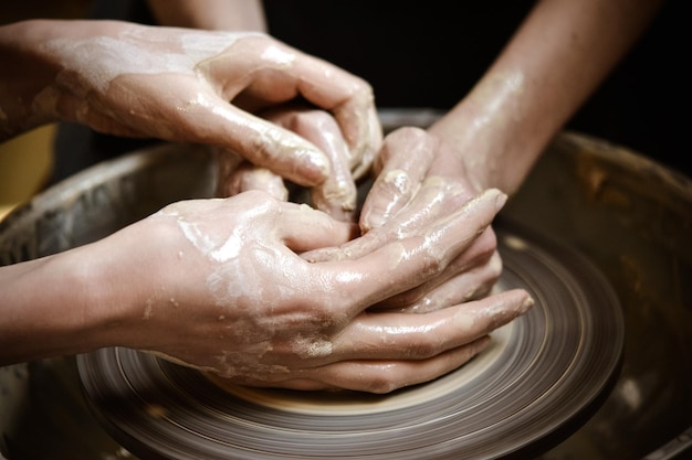 Master class on modeling of clay on a potter's wheel In the pottery workshop