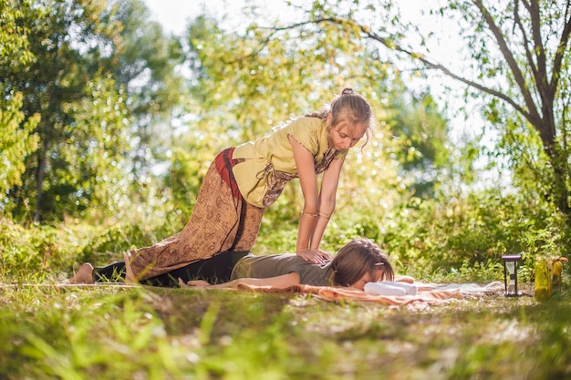 Master massage therapist impliments her massage abilities on the forest ground