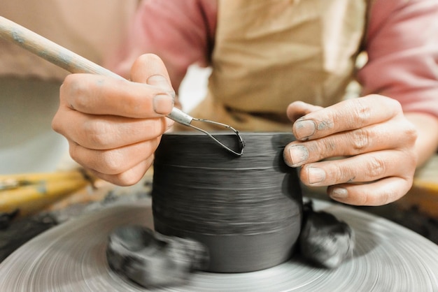 The master of sculpting pottery working in a studio Shaping the clay