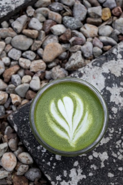 Matcha, green tea in glass cup. Grey stone background. Close up. Top view. Refreshing summer drinks recipes.