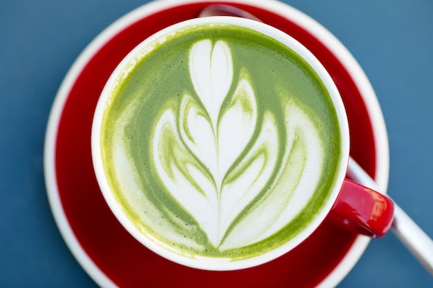 Matcha Green Tea Latte On Blue Background.