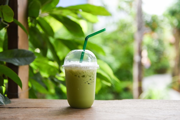 Matcha green tea with milk in plastic glass