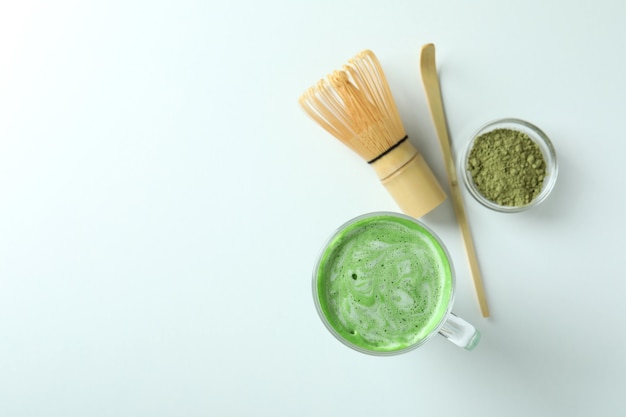 Matcha latte and accessories for making on white background